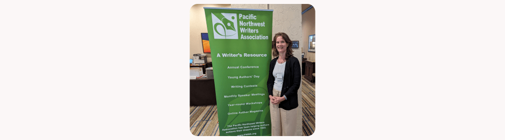Diana Adair standing next to a large green sign about the Pacific Northwest Writer's Association